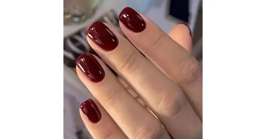 9. Glossy dark red short acrylic nails