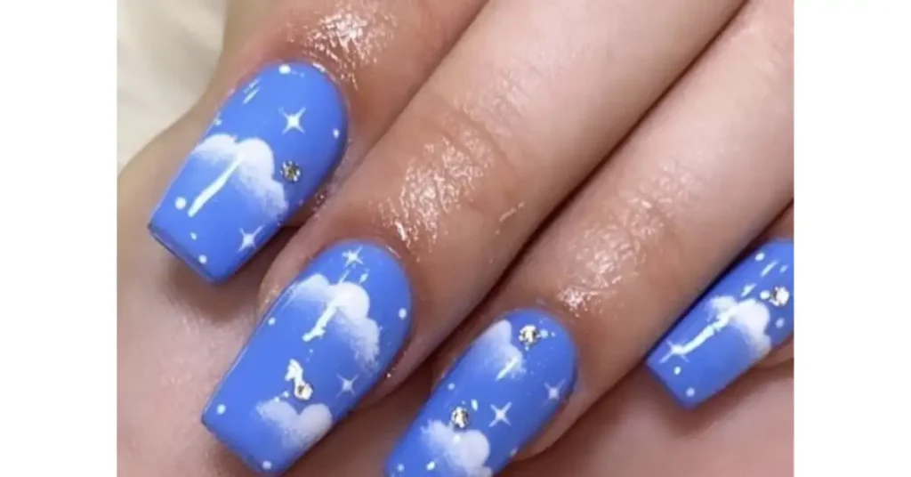 43. night sky acrylic nails with twinkling stars and clouds