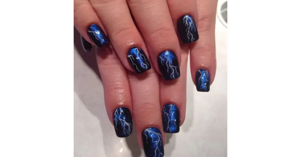 42. Dark blue nails with lightning strikes