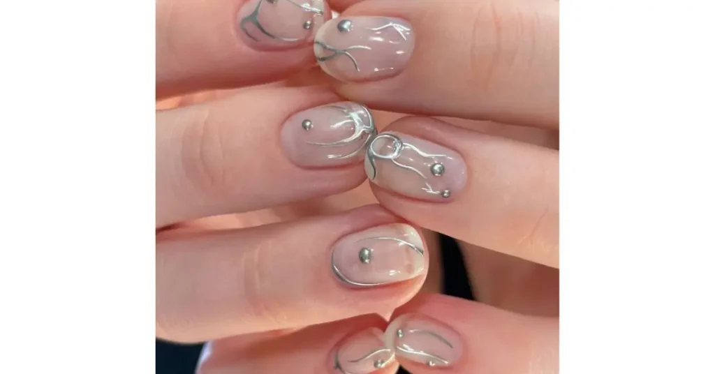 39. Sheer nude nails with mismatched silver nail art