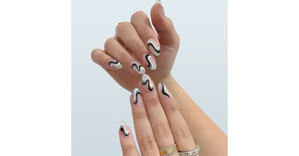 38. Monochrome swirl acrylic nails