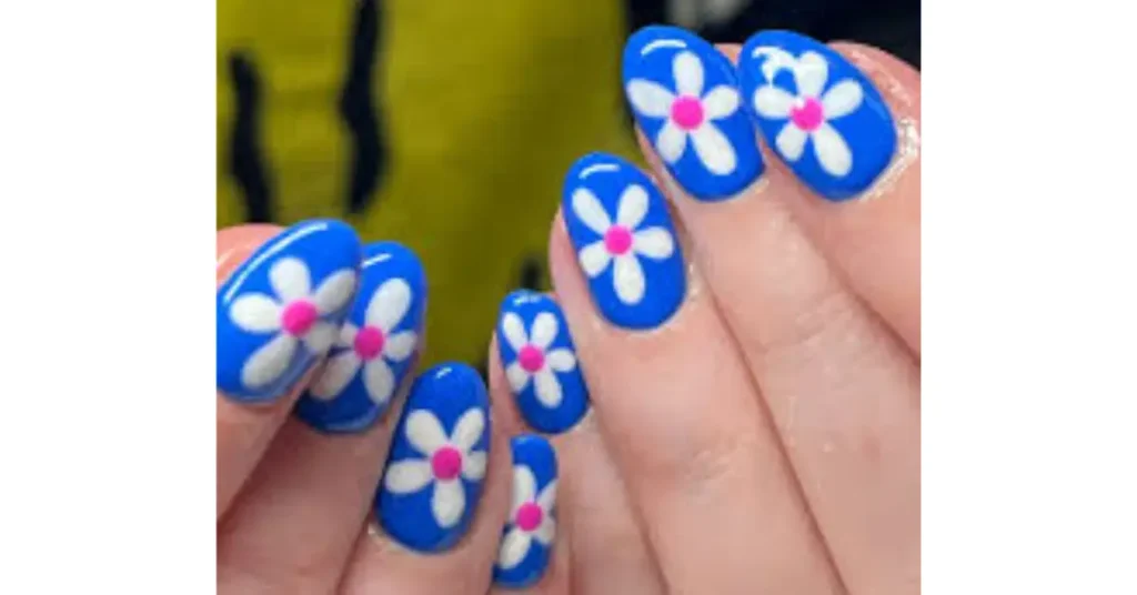 22. Electric blue acrylic nails with white and pink flowers