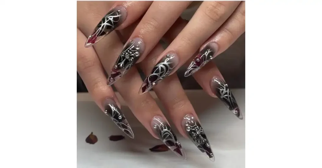 48. Red and black gothic acrylic nails with silver nail art