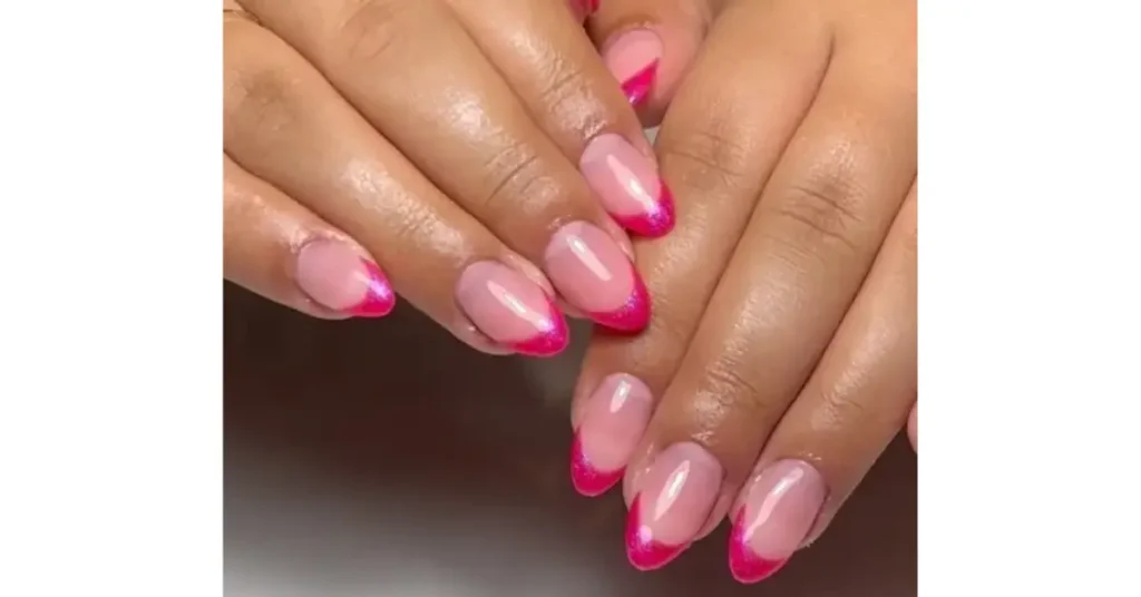 56. Sheer pink acrylic nails with bright pink chrome tips