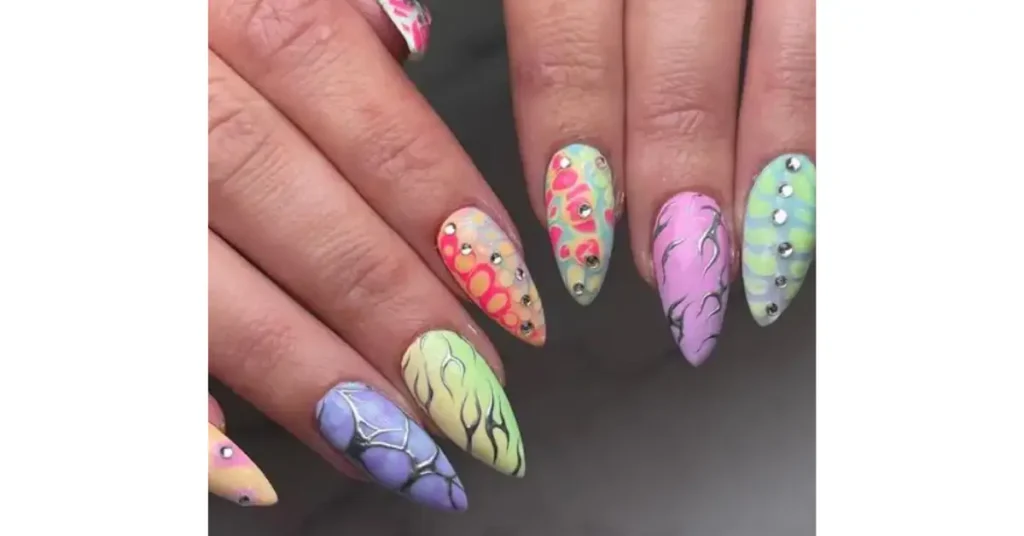 57. Pastel rainbow nails with intricate designs and silver details