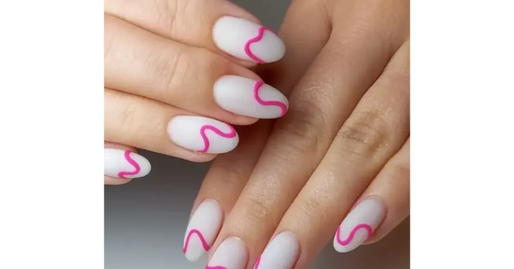 62. Matte milky white oval nails with bright 3D pink squiggles