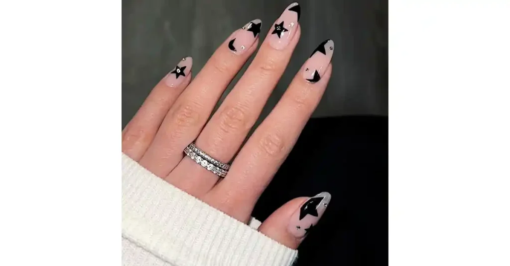 64. Nude almond nails with large black stars